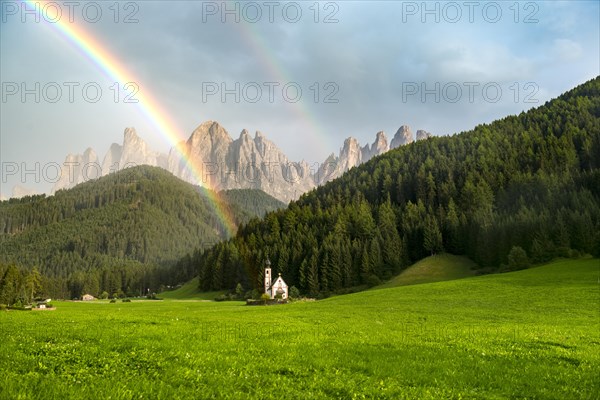 Rainbow in front of the church St. Johann in Ranui