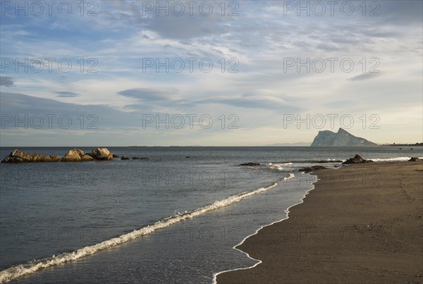 View of The Rock of Gibraltar and La Linea de la Concepcion as seen from the Mediterranean coast in the early morning light