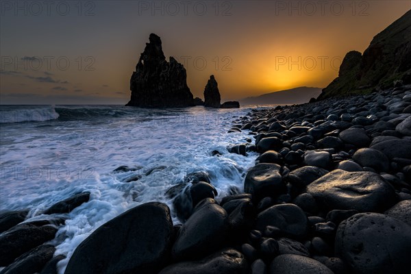 Rock formation Ribeira de Janela at sunrise with black stones at the beach