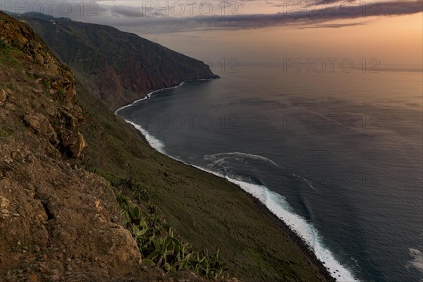 High bank with sea at sunset