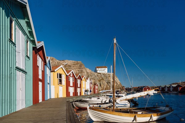 Boats and colourful boathouses in the harbour of Smogen