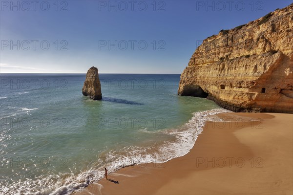 Rock at the sandy beach Praia do Carvalho