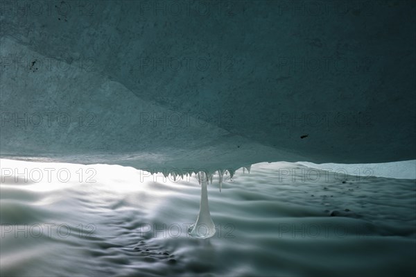 Glacier stream flows under ice cover from Glacier Gate