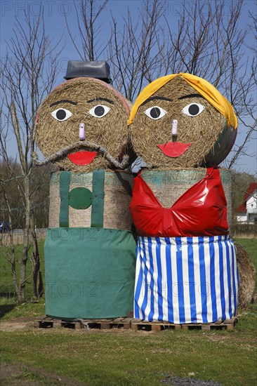 Colourful figures from round straw bales