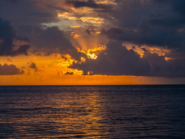 Sunset behind clouds over the sea