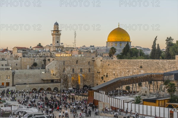 Believers at the Wailing Wall at dusk