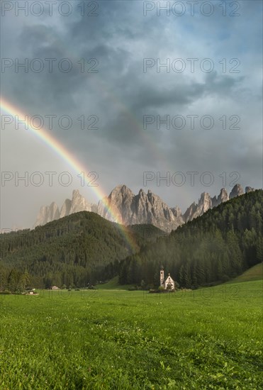 Rainbow in front of the church St. Johann in Ranui