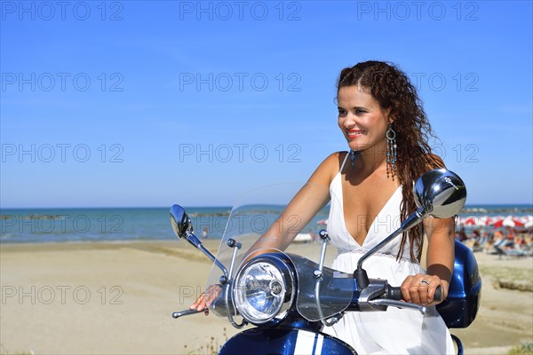 Woman on Vespa scooter