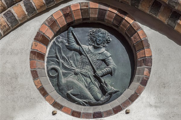 Relief of St. George with the dragon in a rosette at the town hall