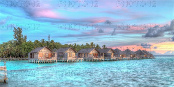 Wooden huts on stilts in lagoon