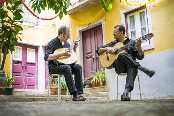 Two fado guitarists with acoustic and portuguese guitars in Alfama