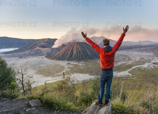 Tourist in front of landscape at sunset