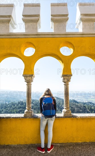 Young woman looking across landscape from Pena Palace