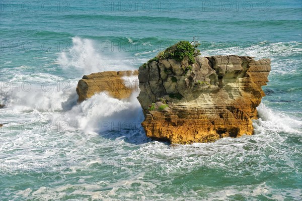 Surf breaking against rock near Pancake Rocks