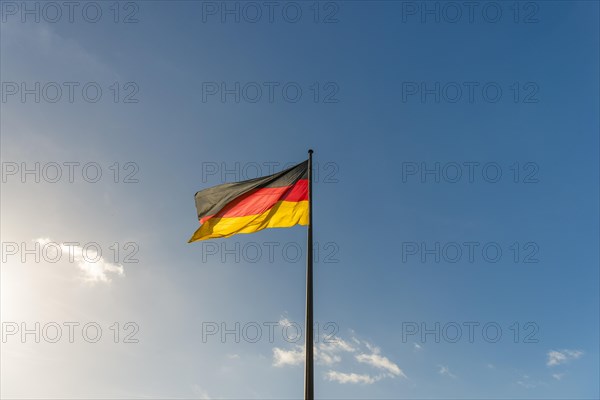 German flag in front of blue sky