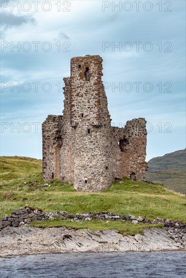 Castle ruin Ardvreck Castle on a peninsula by lake Loch Assynt