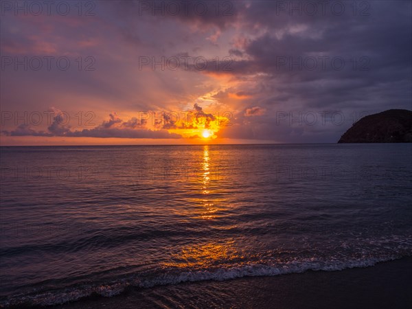 Sunset behind clouds over the sea