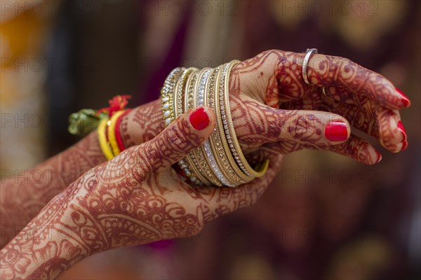 Hands of Indian bride hands painted with henna