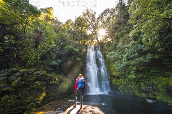 Hiker in front of McLean waterfall