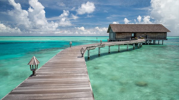 Wooden hut on stilts in lagoon