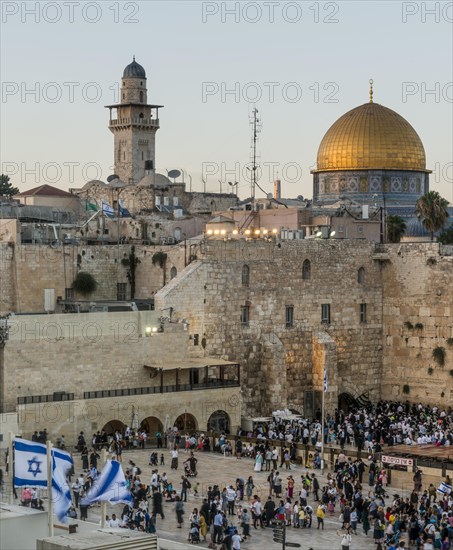 Believers at the Wailing Wall at dusk