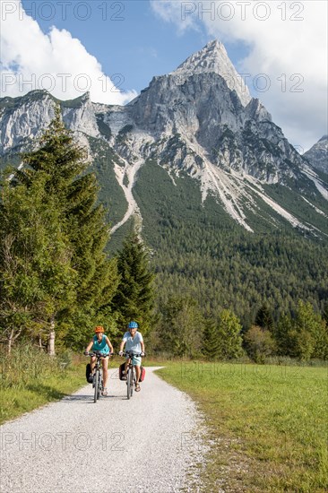 Cyclist with mountain bikes