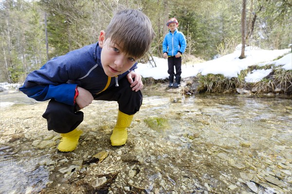 Two boys playing in a brook