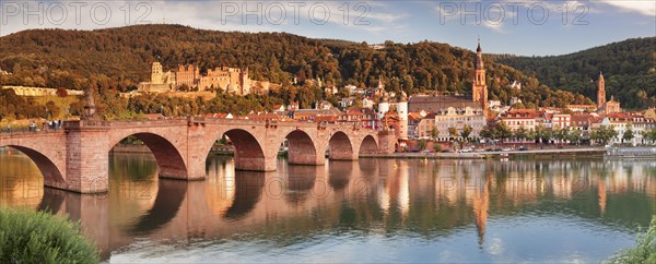 View of Karl Theodor Bridge and Gate over the Neckar River with castle in Heidelberg