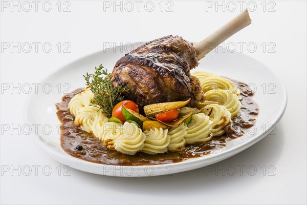 Roasted lamb shank on mashed potatoes