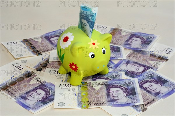 Piggy bank on twenty pound British banknotes