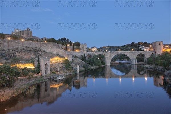 San Juan de los Reyes Church and Puente de San Martin bridge reflected in the Tajo River