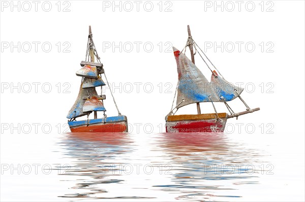 Two crafted sailboats