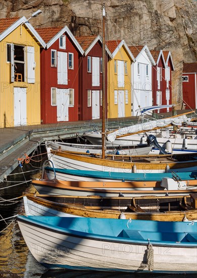 Boats and colourful boathouses in the harbour of Smogen