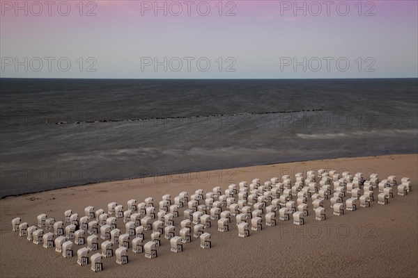 White beach chairs on the beach at twilight