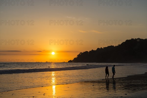 Man and woman strolling on the beach