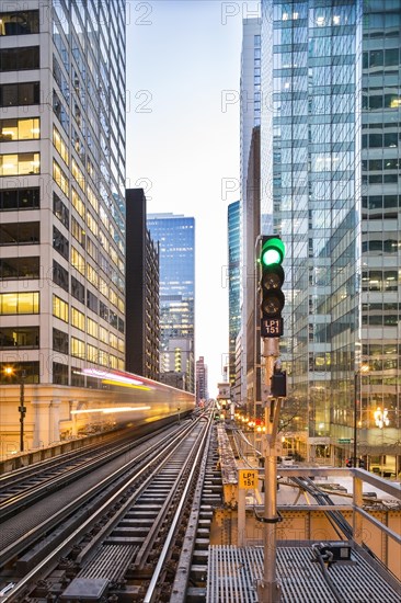 Train arrives between skyscrapers