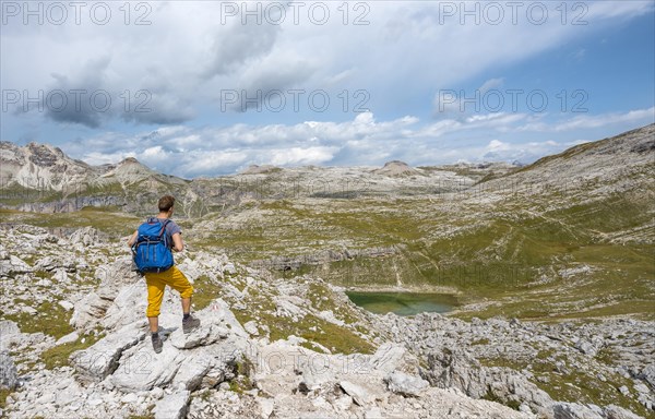 Hikers on the circular trail around the Sella Group near Lake Lech de Crespeina