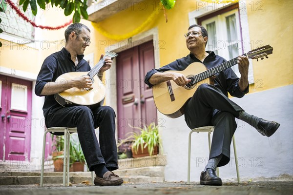 Two fado guitarists with acoustic and portuguese guitars in Alfama