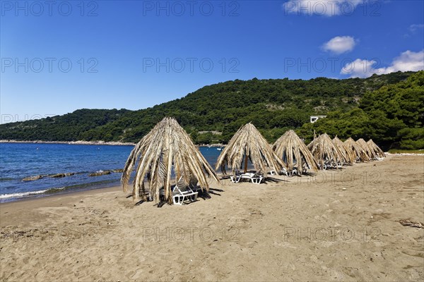 Sunshades at the sand beach at Saplunara