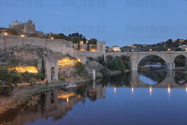 San Juan de los Reyes Church and Puente de San Martin bridge reflected in the Tajo River