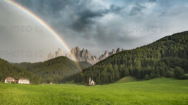 Rainbow in front of the church St. Johann in Ranui