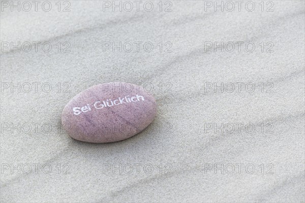 Be Happy inscribed in small stone