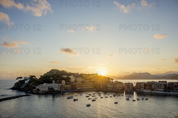 View of the village with harbour in the bay Baia del Silenzio at sunset