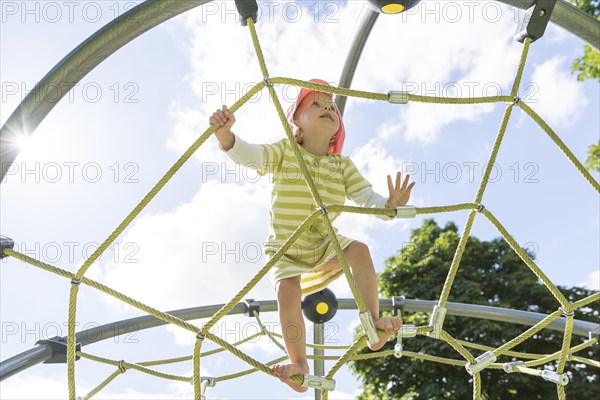 Toddler on climbing frame at a playground