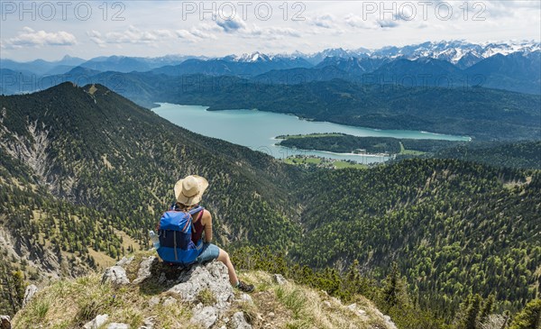 Hiker looking towards Lake Kochel from Heimgarten peak