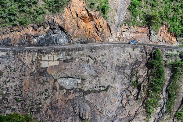 Narrow street in cliff with trucks