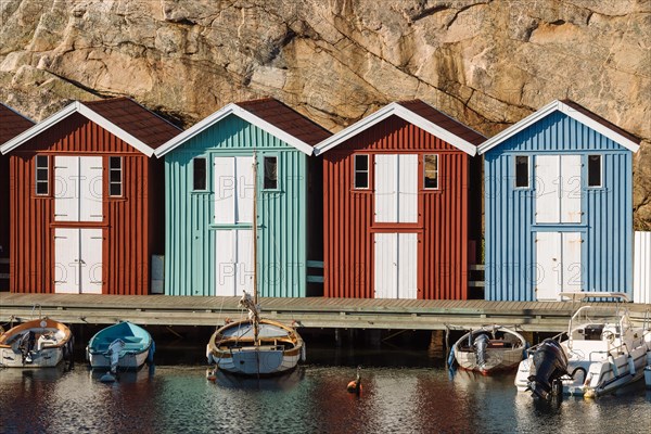 Boats and colourful boathouses in the harbour of Smogen