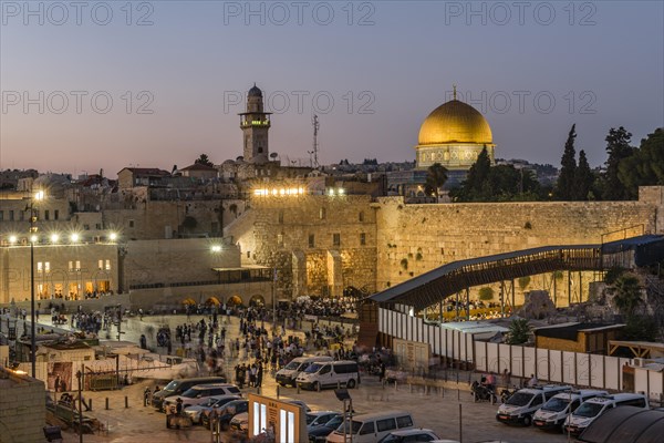 Believers at the Wailing Wall at dusk