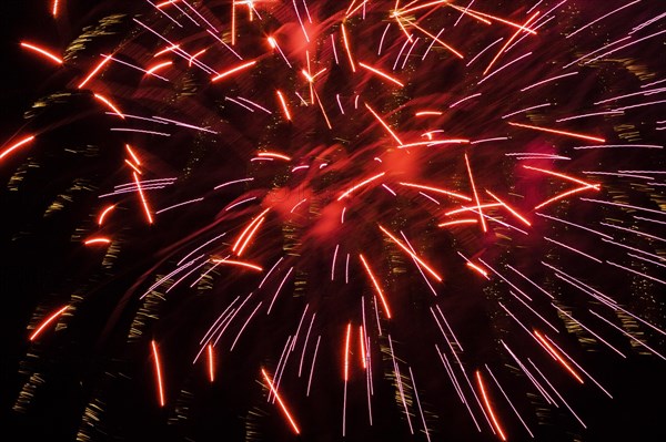 Red fireworks in night sky