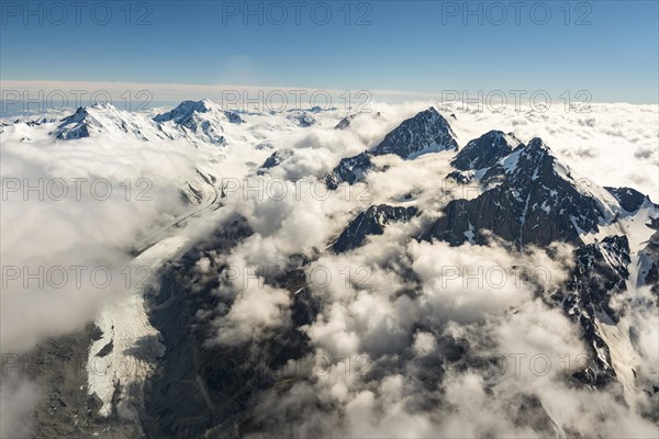 Tasman glaciers and peaks of mountains through clouds